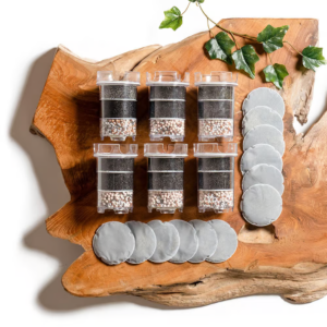 The Lotus Vita ENYA water filter pitcher box shown next to the Annual Filterpack box, which includes a one-year supply of replacement filters and pads.